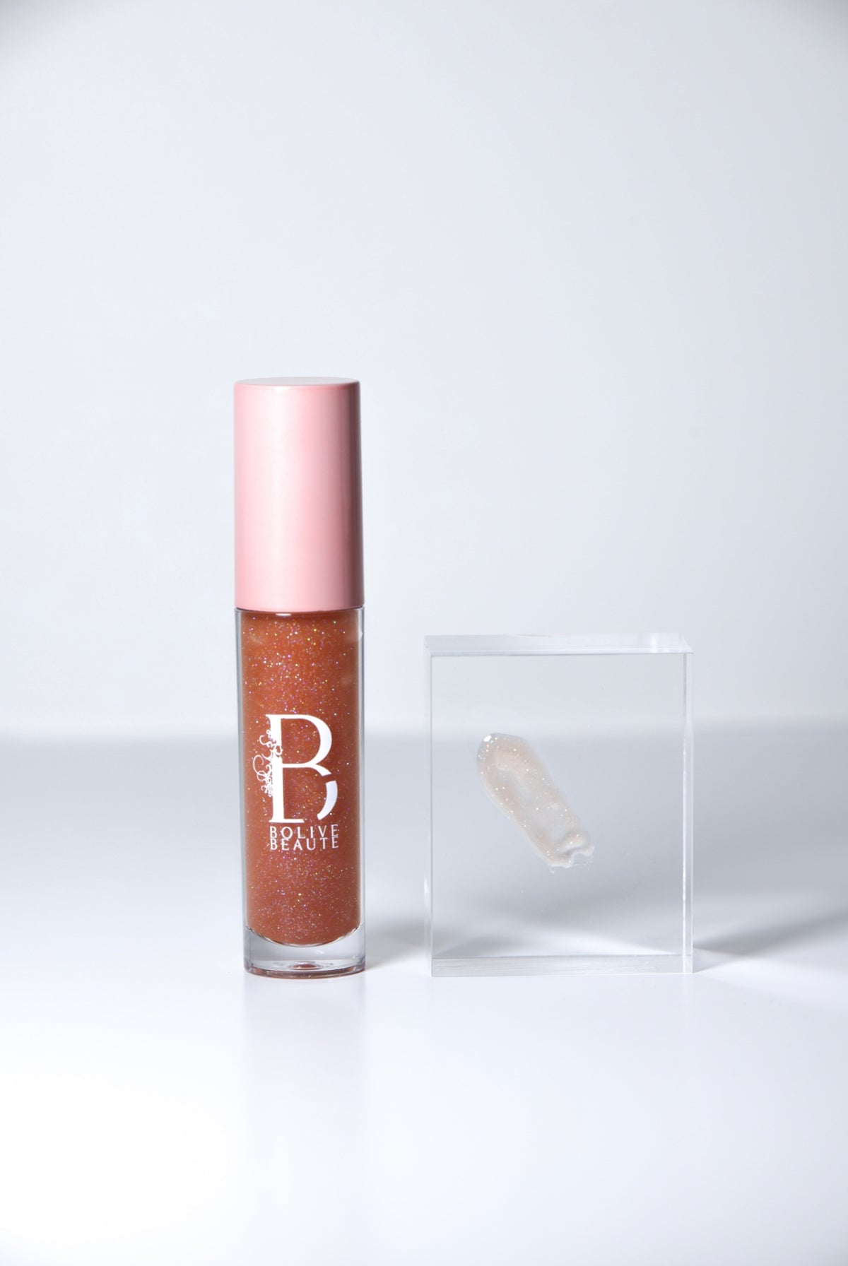 Glow'd Up sheer brown shimmer lip gloss by Bolive Beauté